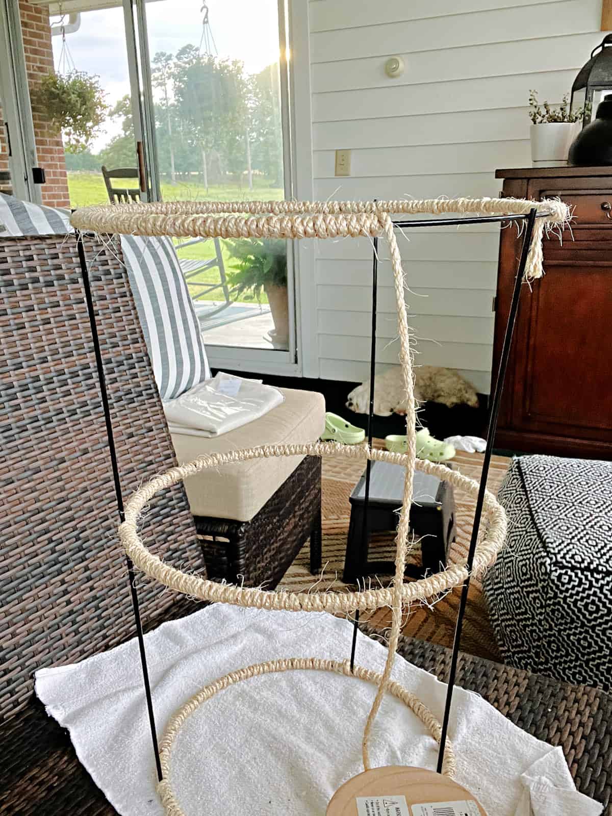 Easy DIY Plant Stand image wrapping twine around ring on tomato cage