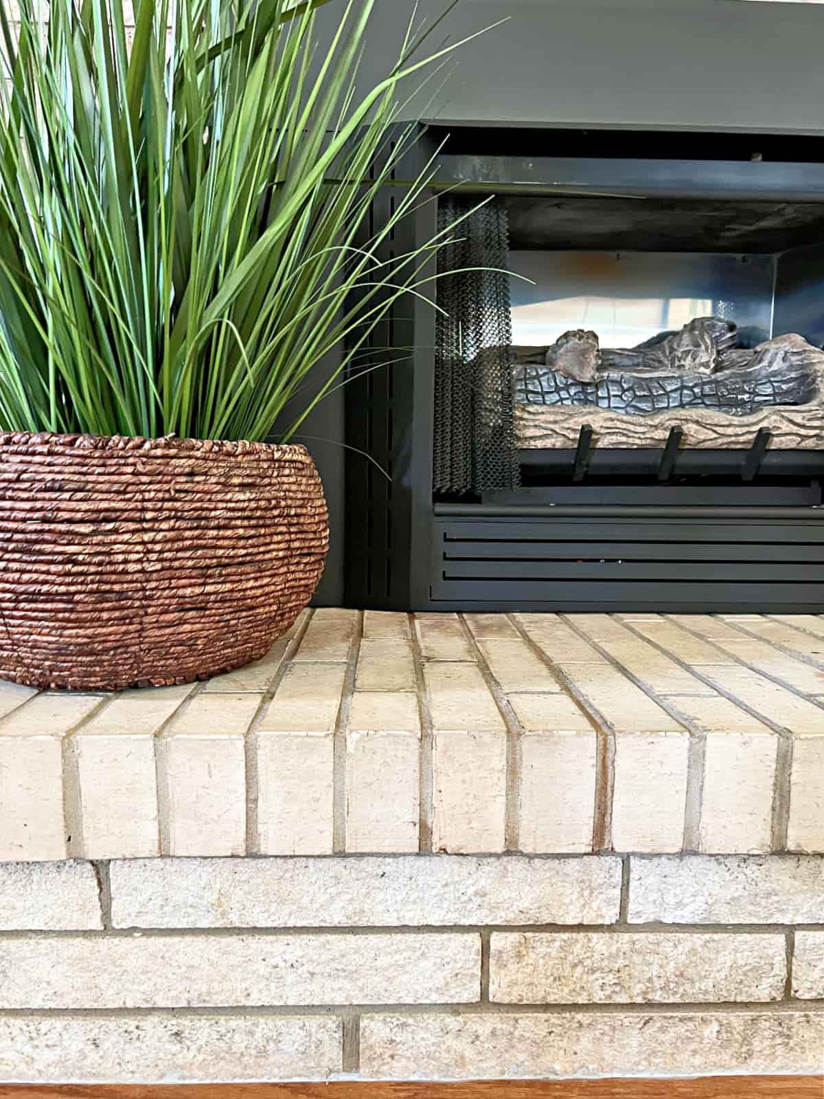 fireplace with brass accents painted black