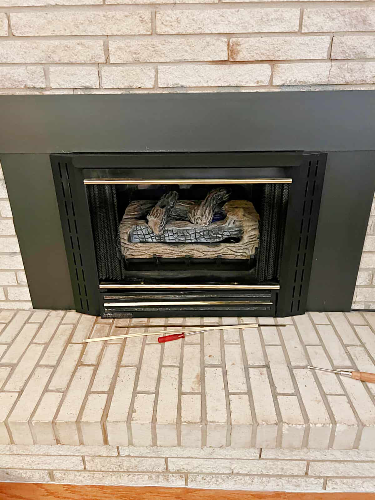 black fireplace with brass accents