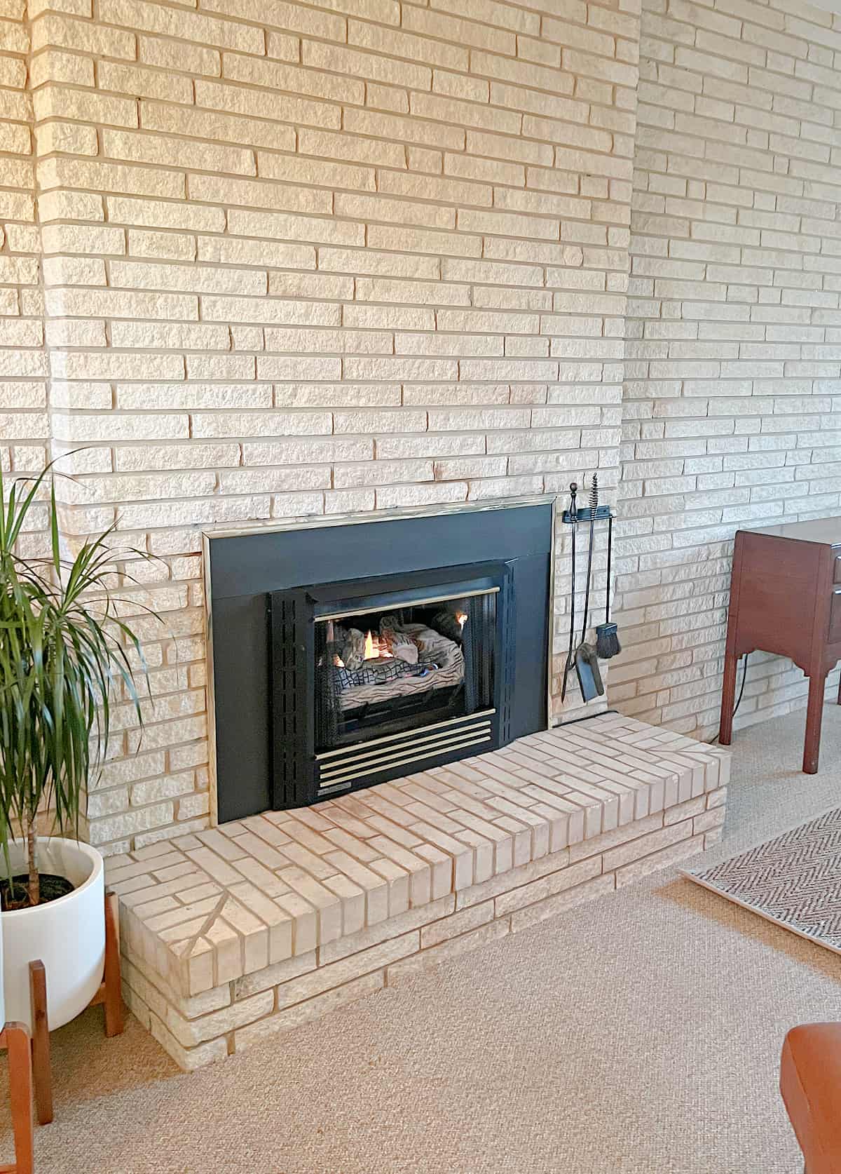 black fireplace with brass accents