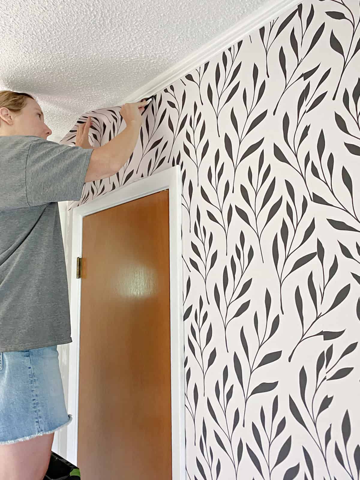 hanging wallpaper over a closet in an entryway