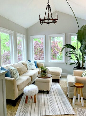 sunroom with windows all around and sectional sofa
