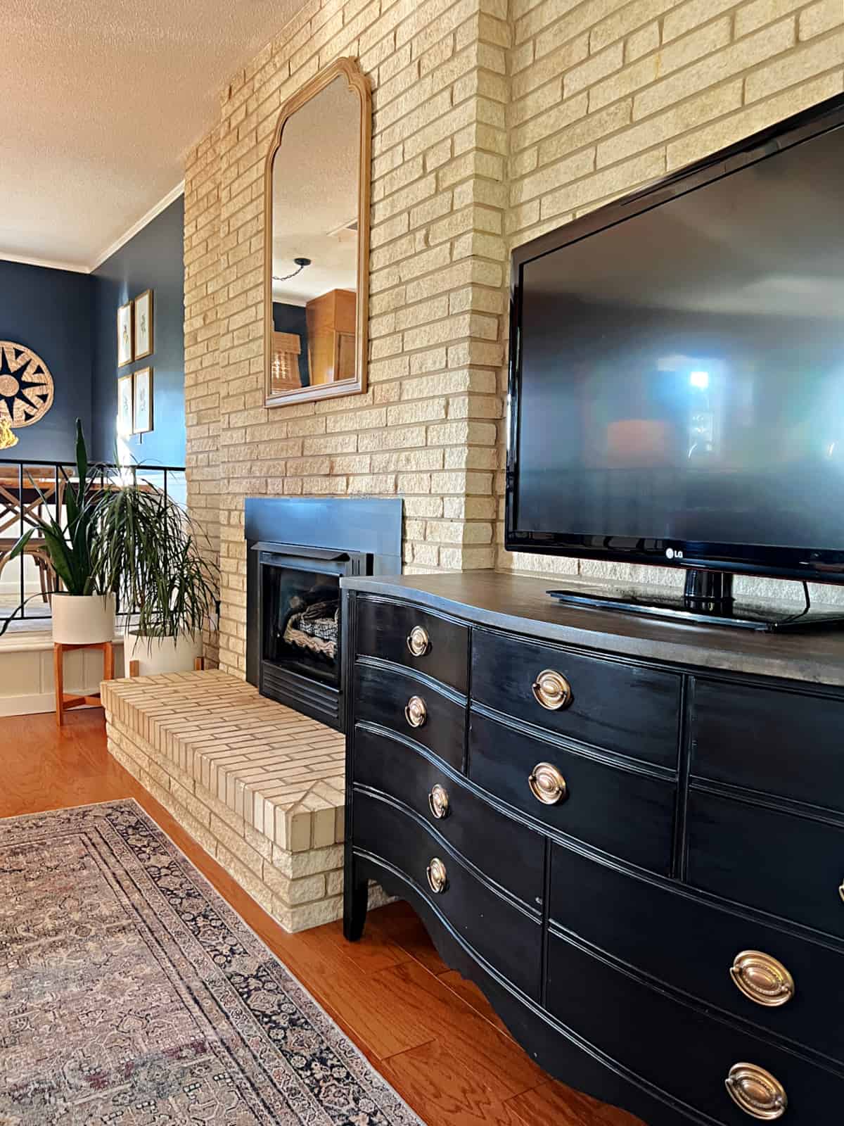 long narrow living room with black media cabinet and tv