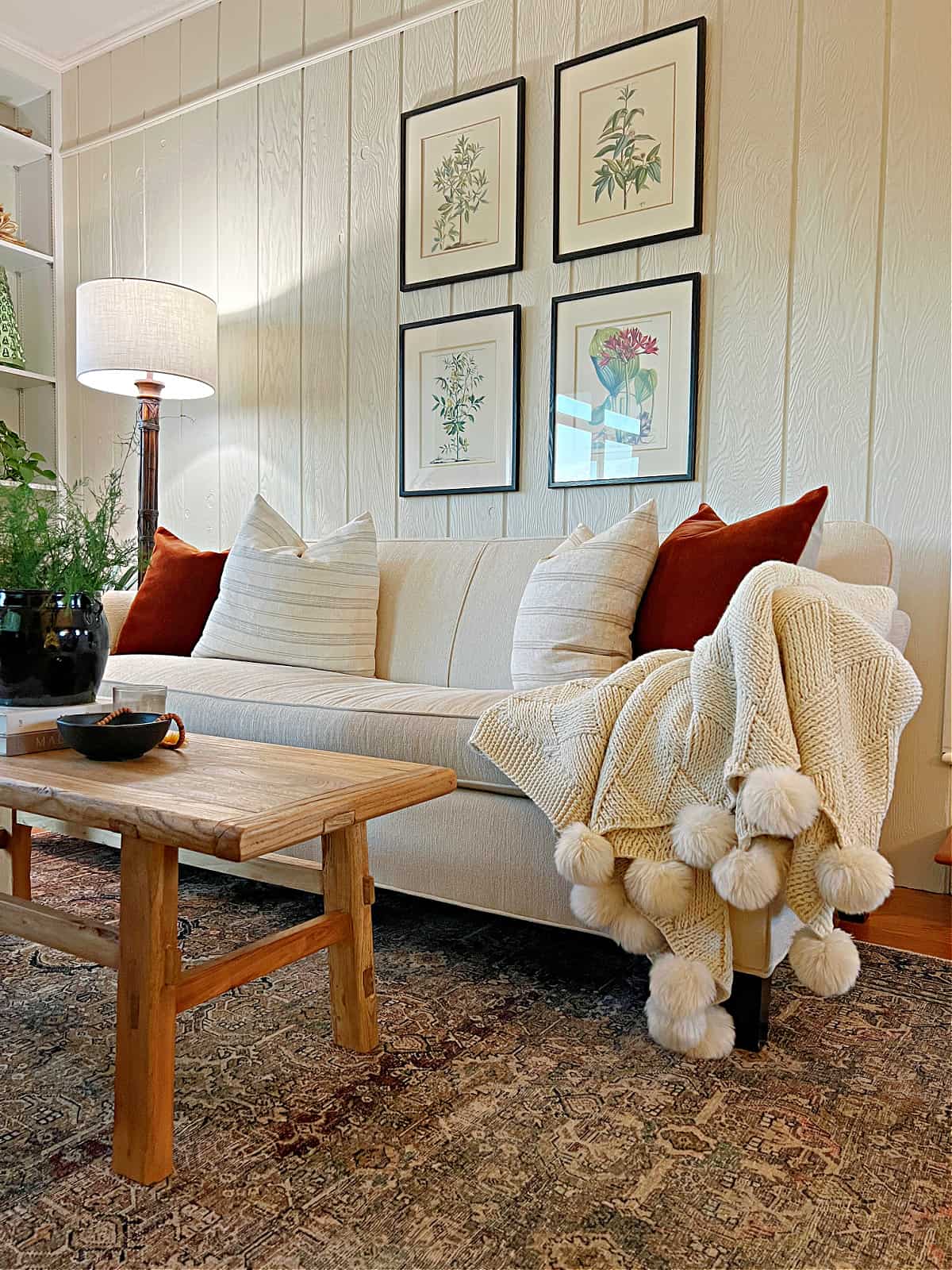 narrow living room with sofa and coffee table decorated