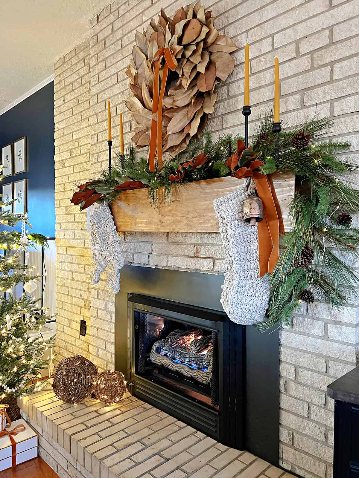 stone fireplace and mantel decorated for Christmas