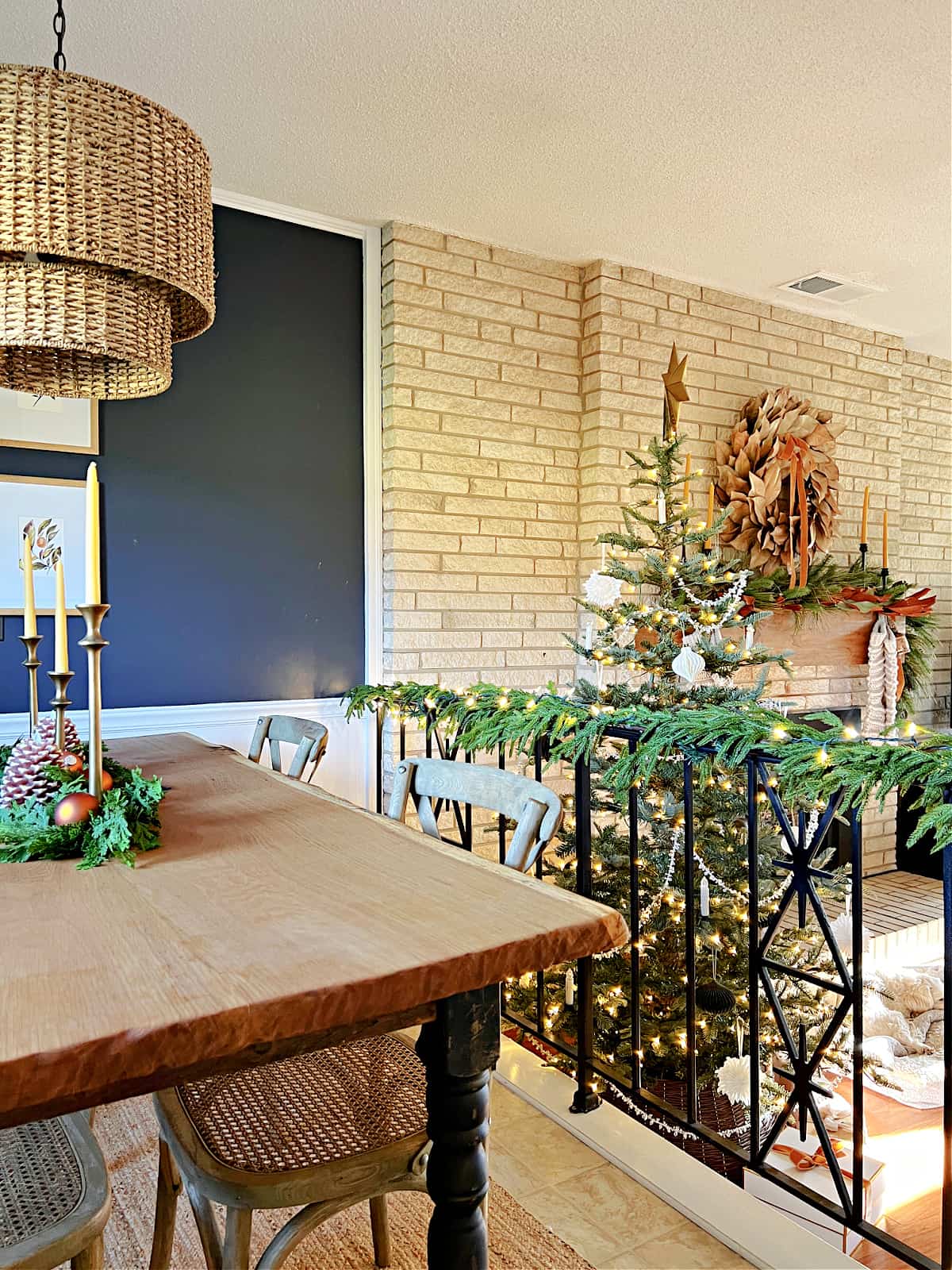 dining nook decorated for Christmas overlooking the living room and Christmas tree