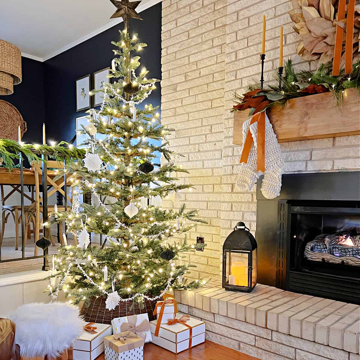 Christmas tree next to a living room fireplace