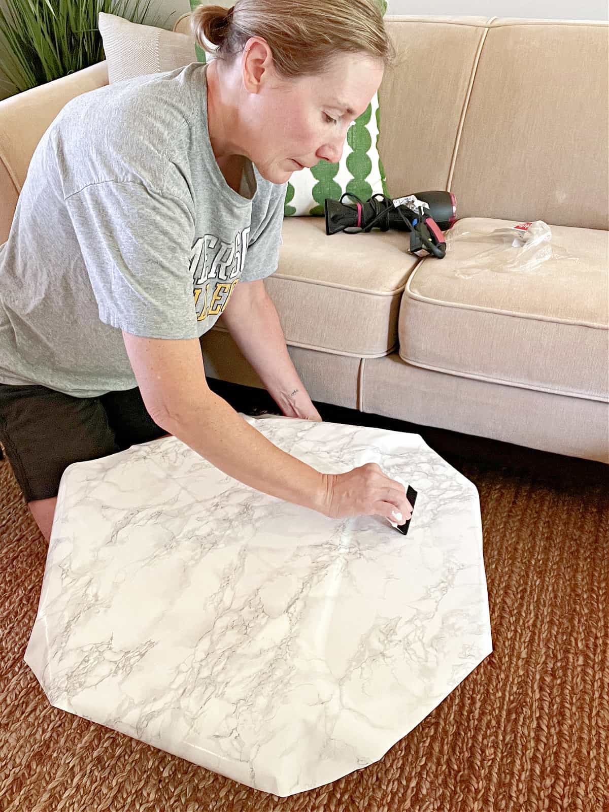 smoothing contact paper on coffee table top