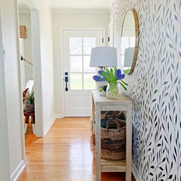 small entryway with white walls and wallpaper