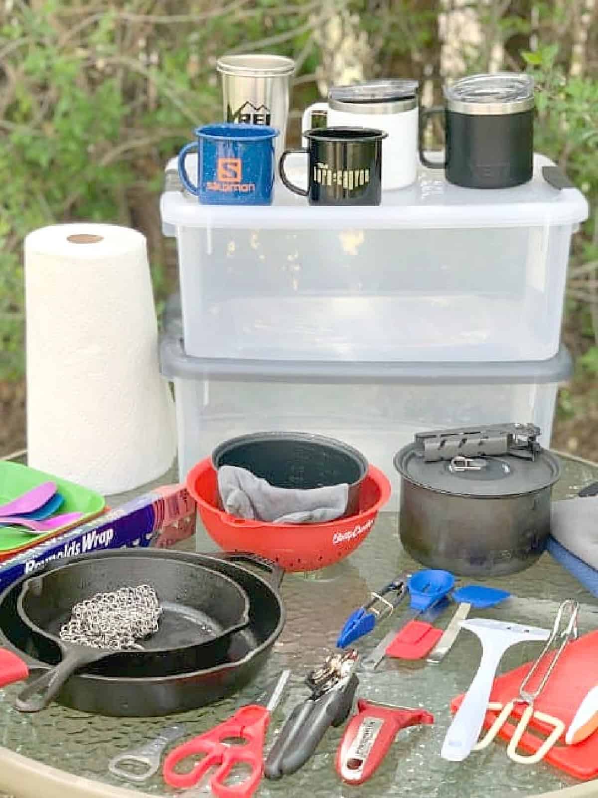 Camp Kitchen Gear & Packing List pic kitchen camping gear spread out on glass top table