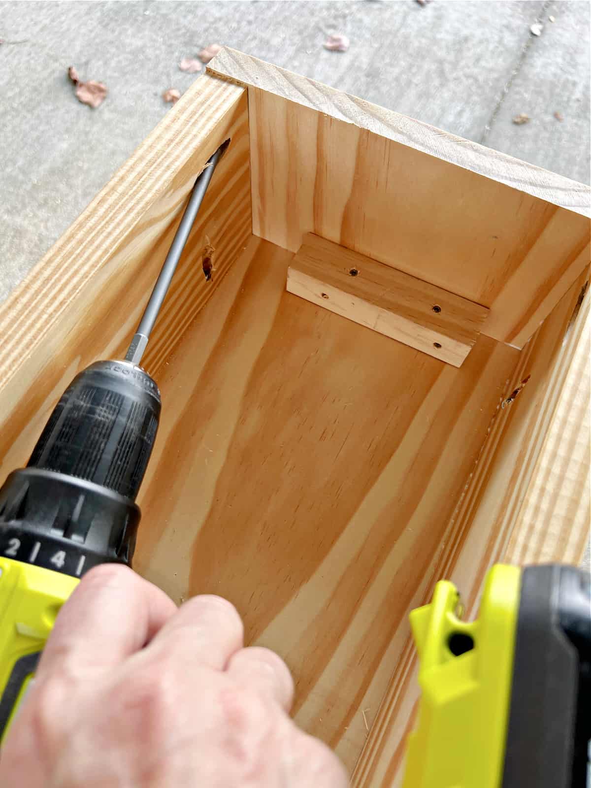 using drill to screw in screws to pine wood box
