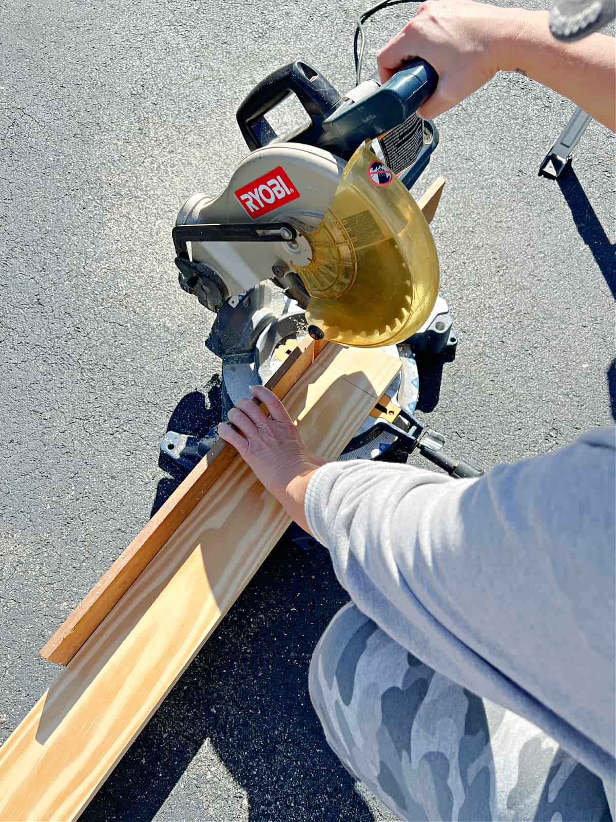 using chop saw to cut pine boards for fireplace mantel
