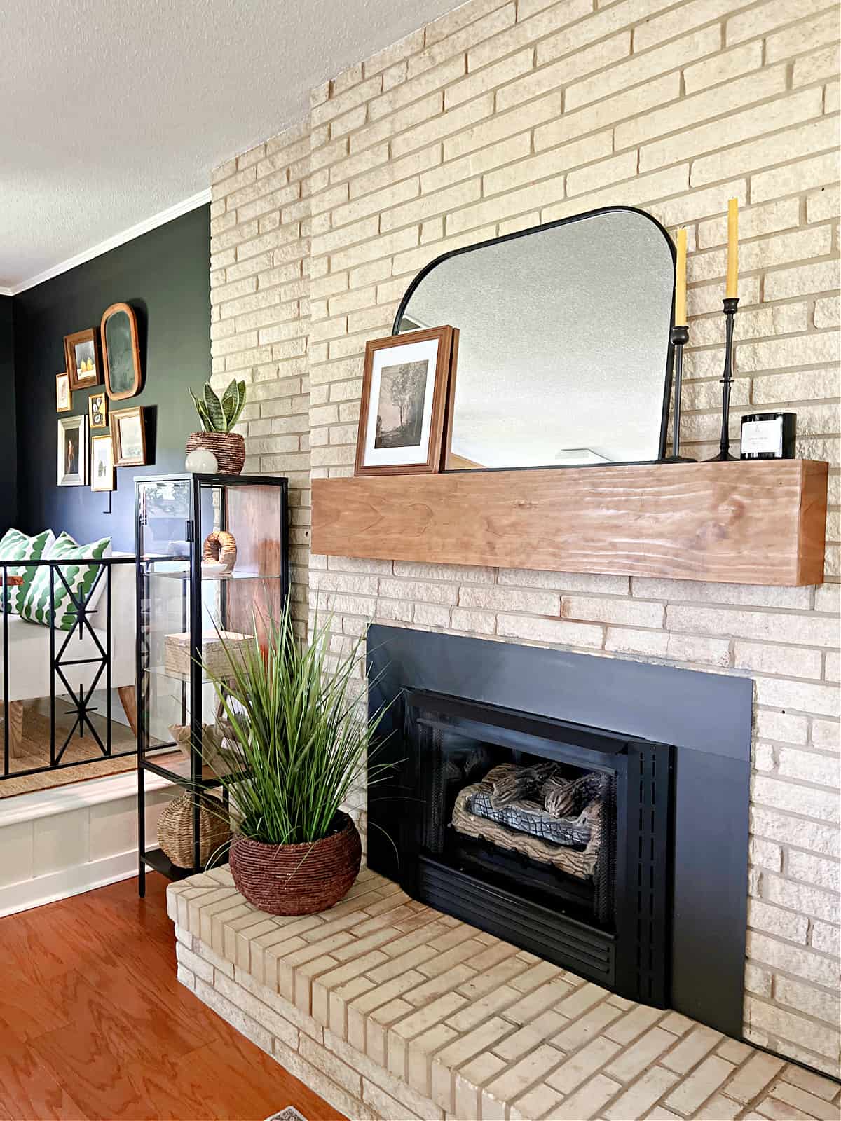decorated DIY wood mantel shelf hanging on stone fireplace