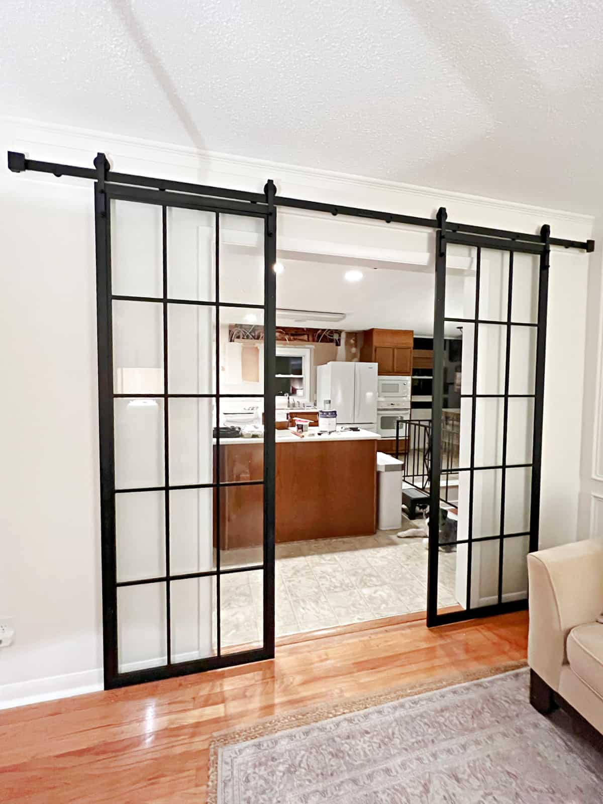 installing glass and metal sliding doors in a living room doorway