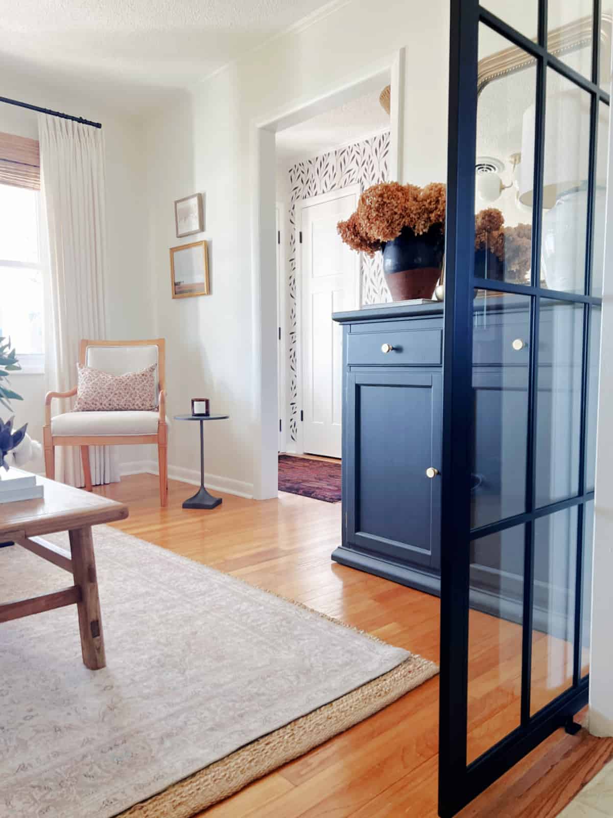 small living room with chair in corner and black cabinet