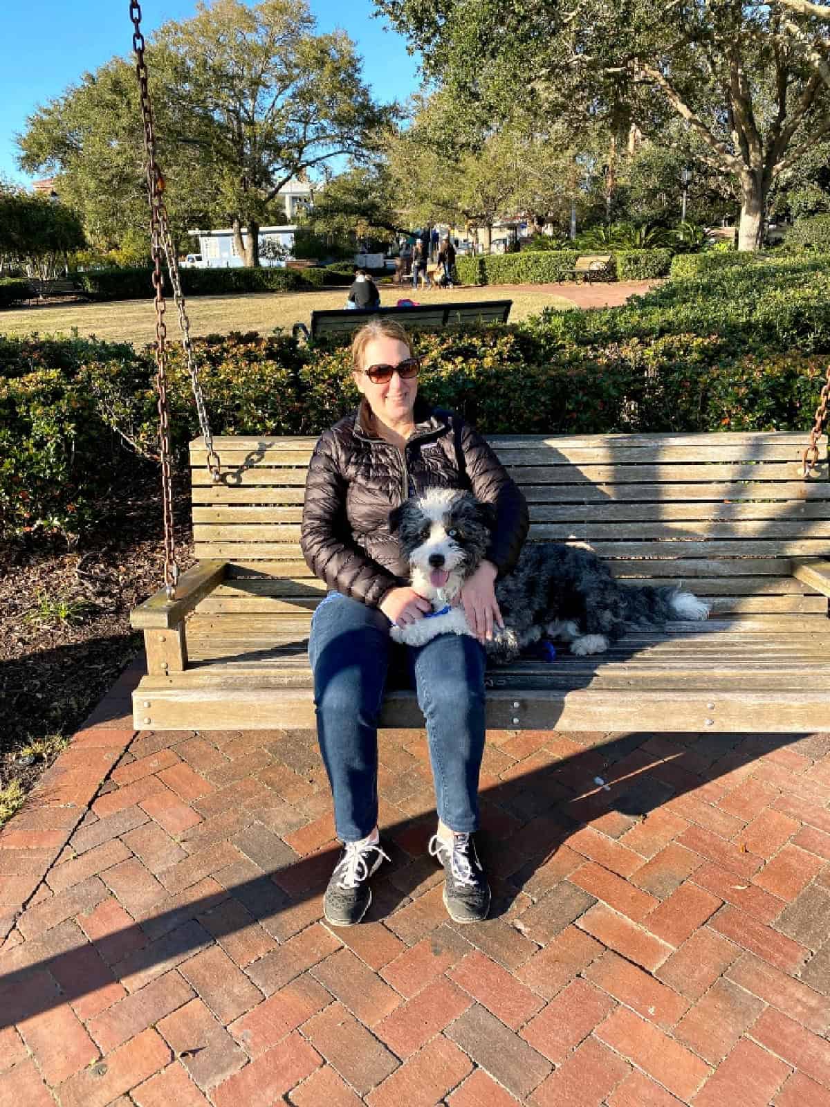 woman sitting on a bench with a dog