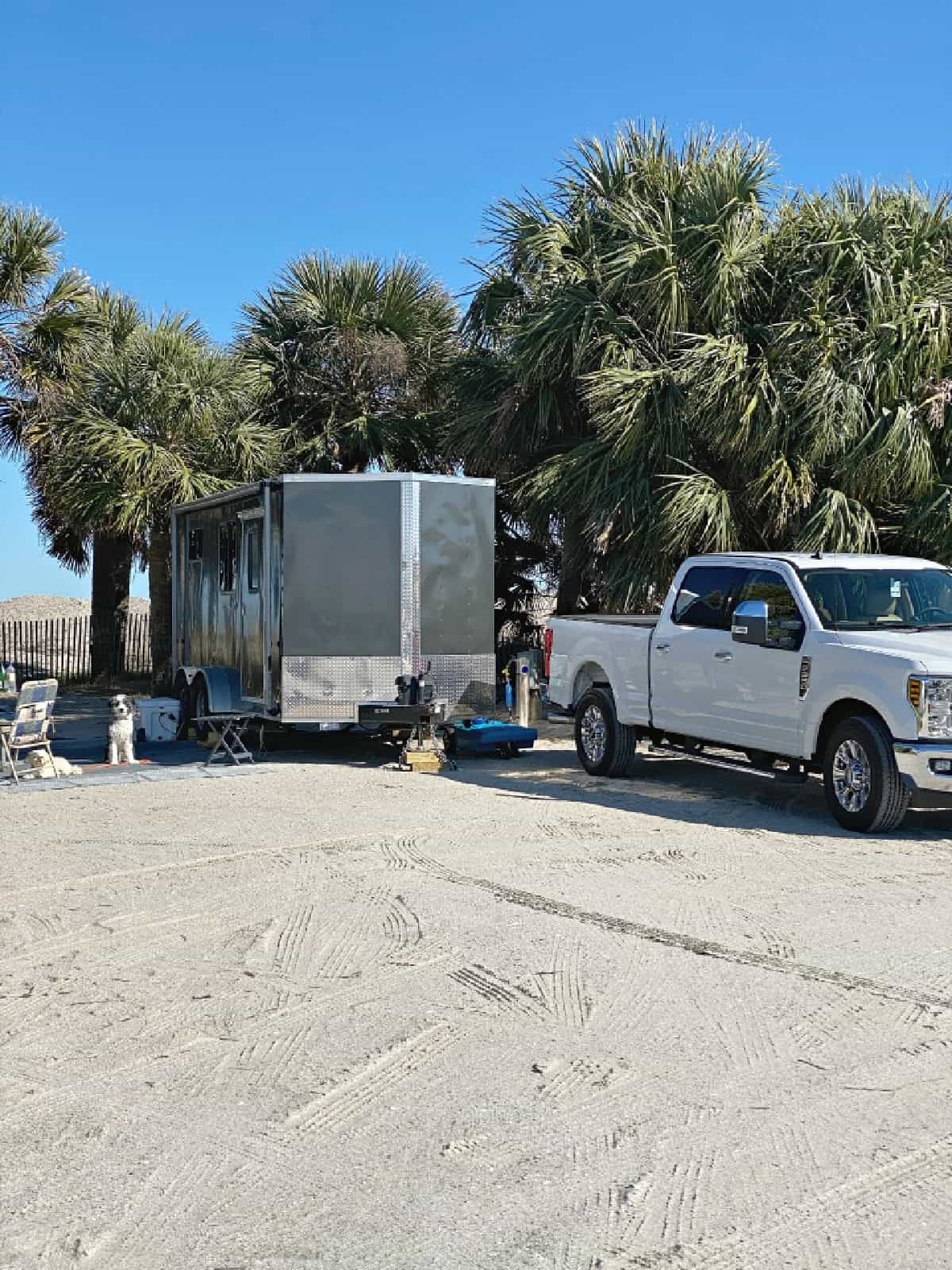 cargo trailer camper in Edisto Beach campsite with palm trees