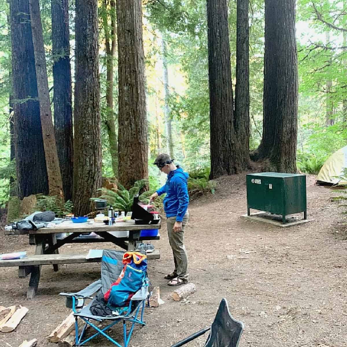 person cooking at campsite