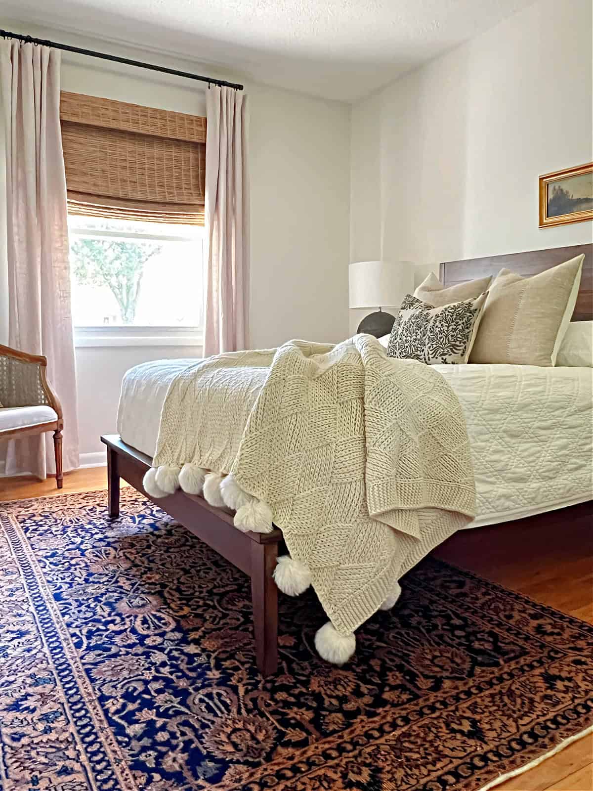 small guest bedroom with bed and vintage rug
