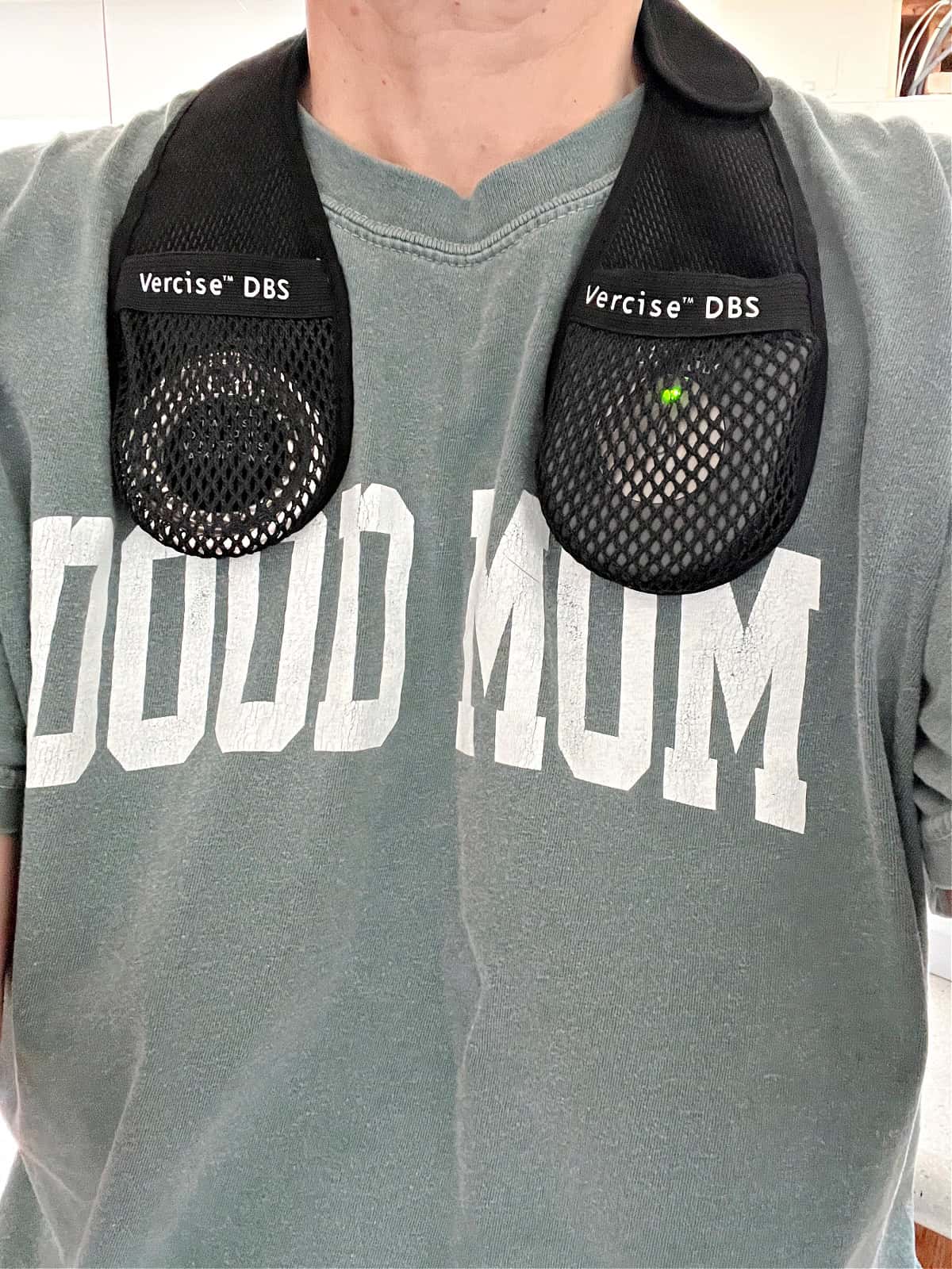 woman in tee shirt with DBS charger around neck