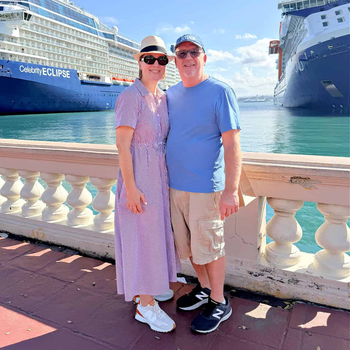 man and woman posing in front of ship