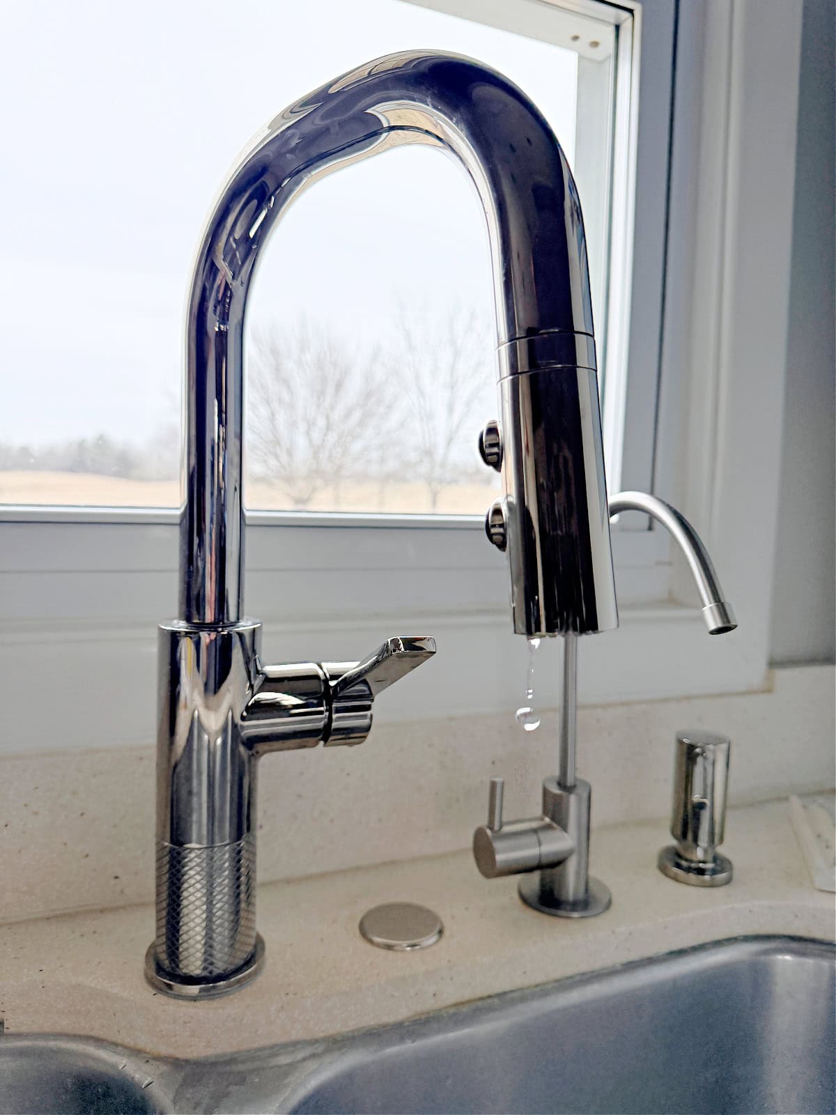 water dripping out of a kitchen faucet to prevent frozen pipes