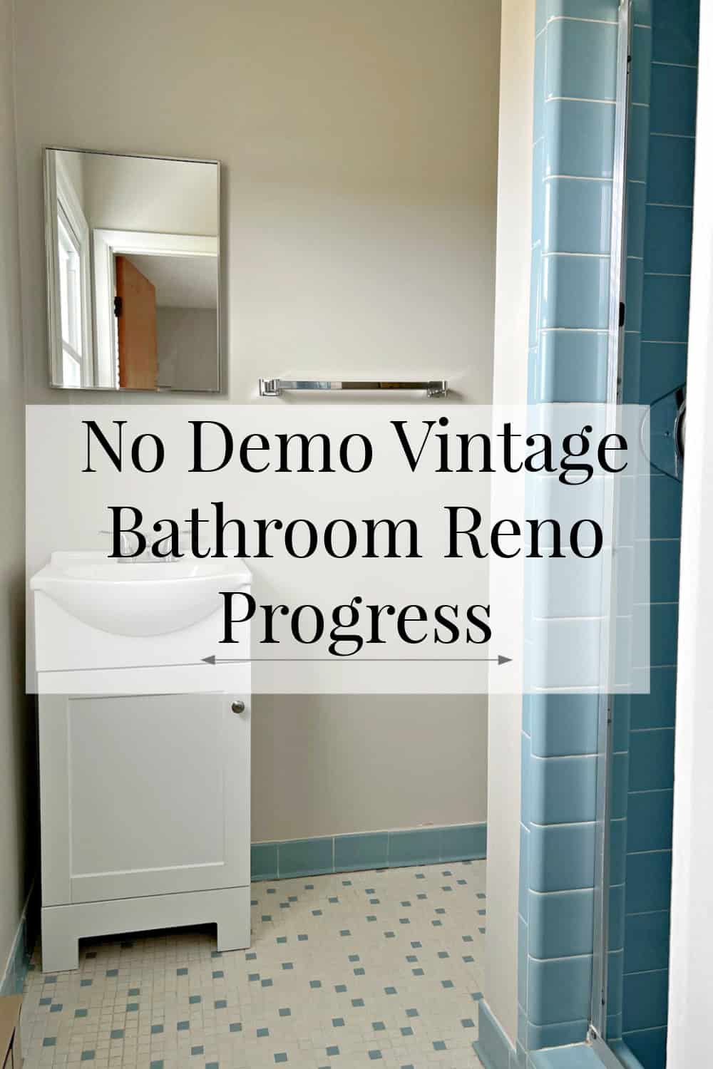 small vintage master bath with blue tile and large banner graphic