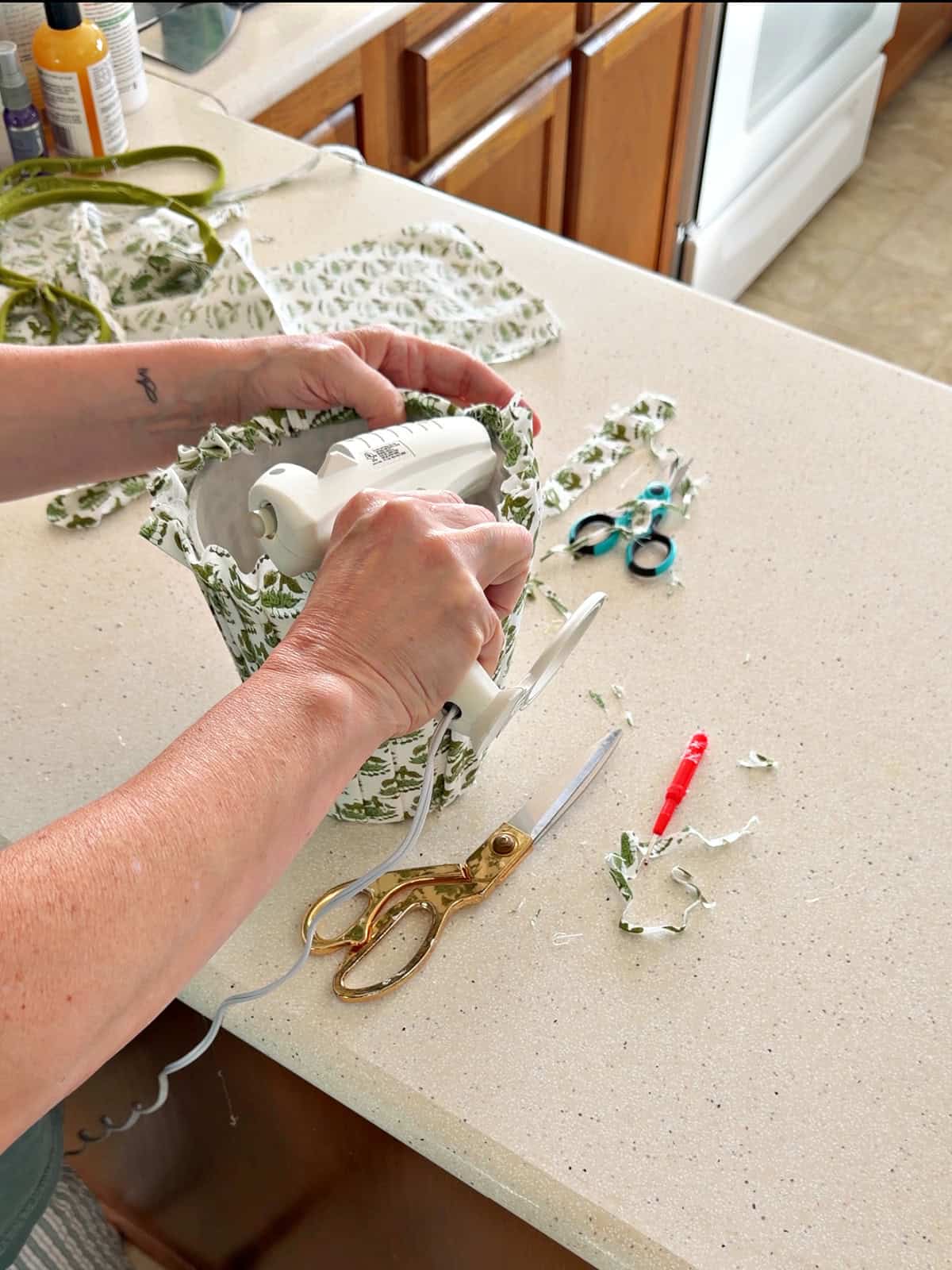 adding glue to DIY pleated fabric lampshade